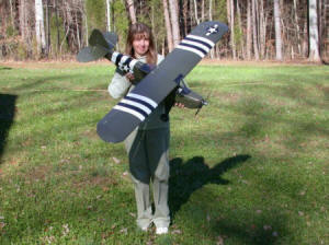 Supermodel Melanie Blattenberger with Kirt's Great Planes Cub 20 finished in L-4 Grasshopper military colors. Futaba 6-channel radio - Airplanes and Rockets