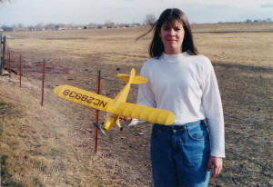 Sally Blattenberger (now Sally Cochran) holding her Comet J-5 Cub Cruiser - Airplanes and Rockets