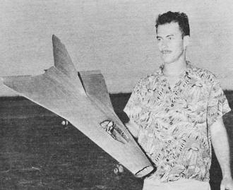 Author-designer-experimenter Schindler with first test version of his delta wing free flight ducted fan - Airplanes and Rockets