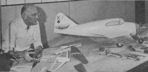 AMA member, modeler AAK, in his Dearborn, Mich., home workshop with latest radio controlled plane - Airplanes and Rockets