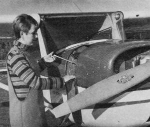 Senior Linda Harding checks oil in preflight check - Airplanes and Rockets