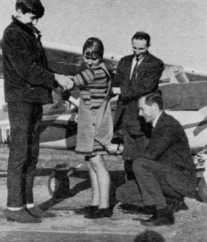 Don Smith and mechanics instructor, Lawrence Johnson hold student, Linda Harding - Airplanes and Rockets