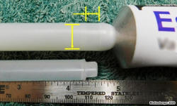 Empty volume inside applicator between bottom of plunger and top of tube